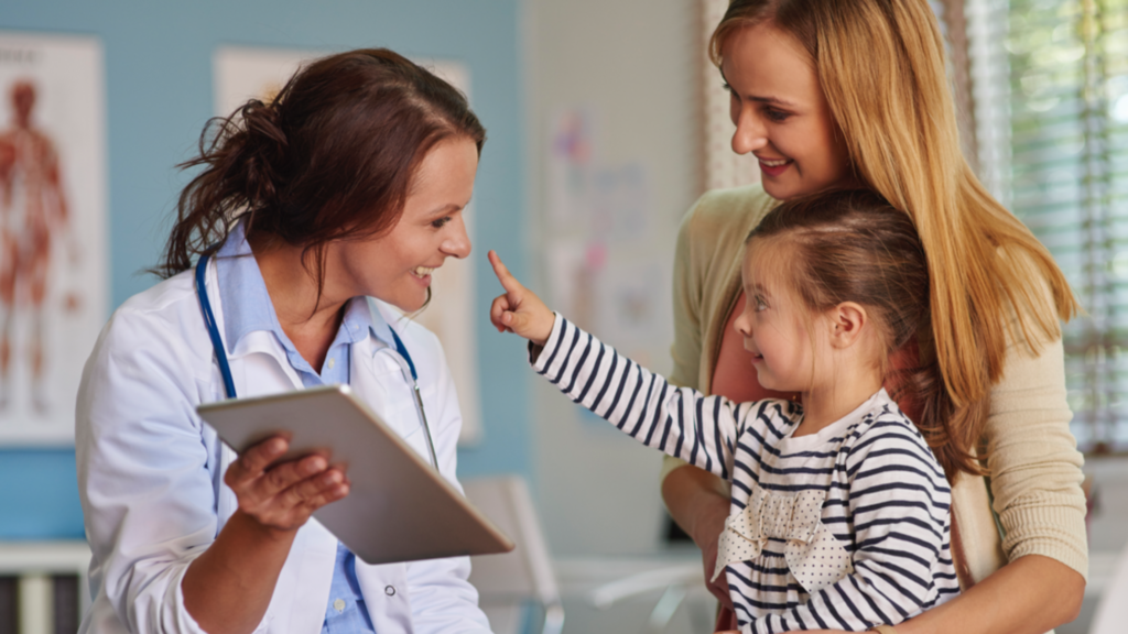 Doctor discussing child development with parents, explaining why doctors recommend chess for kids to improve focus, memory, and thinking skills
